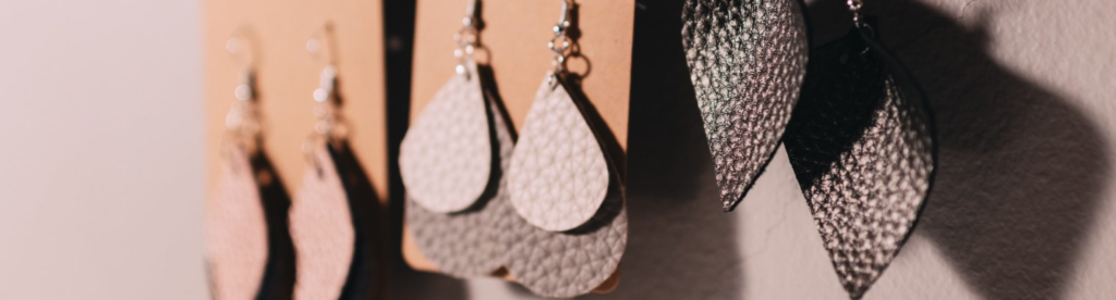 Image of three pairs of earrings hanging on a cork board